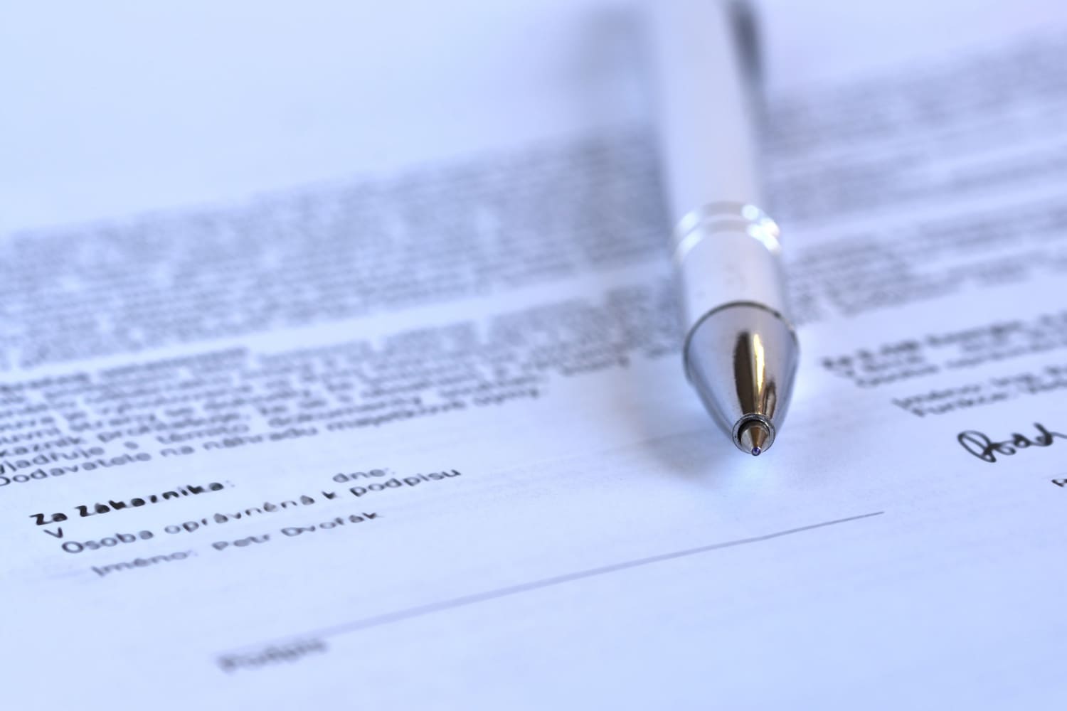 Man reviewing passport and documents at office desk